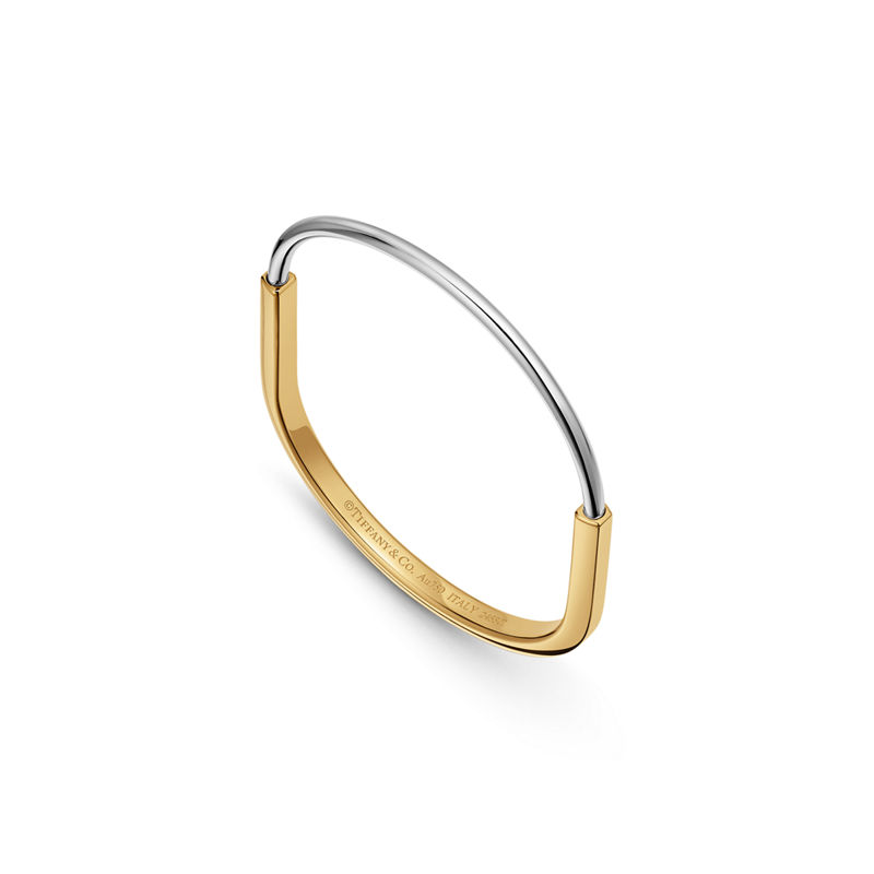 Tiffany & Co. Tiffany Lock Brazalete estrecho de oro amarillo y blanco Liquidación