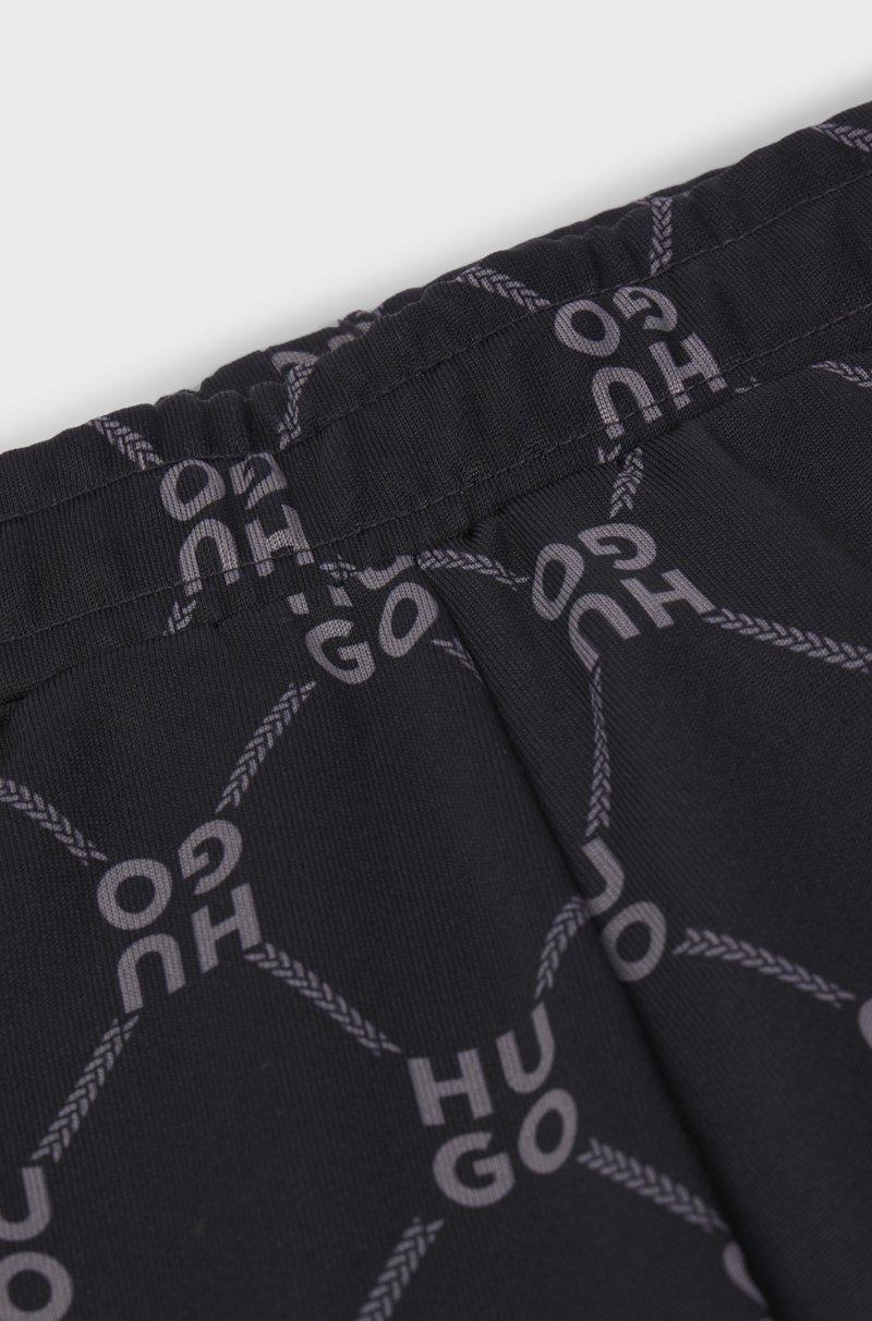 Hugo Boss Pantalones de chándal loose fit para niños con logo apilado estampado Venta caliente