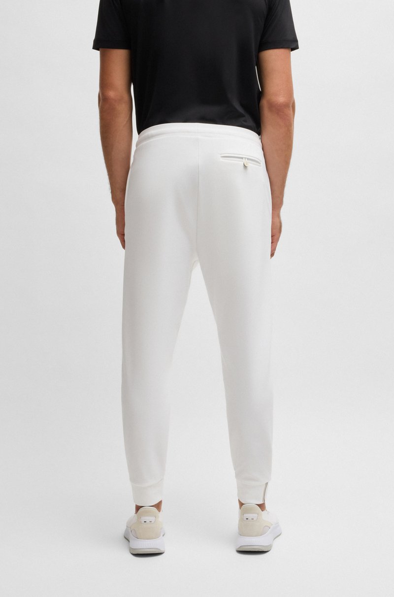 Hugo Boss Pantalones regular fit en tejido de gabardina elástico con detalle de logo Descuento